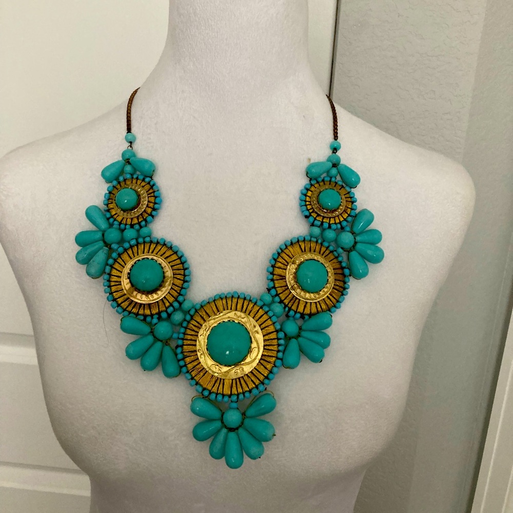 This beautiful statement necklace made of gold and turquoise beads.